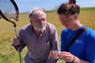 George and RSPB Uists Warden Heather Beaton with the great yellow bumblebee© Guthrie O’Brien 