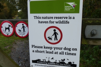 Dog information sign at Tadnoll Nature Reserve