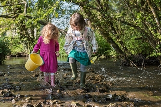 Children playing in the River Hooke by Katharine Davies 