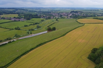 Aerial photo of the Court Farm site featuring fields and hedgerows