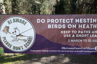 Banner to encourage people to keep to paths and use a short lead for dogs