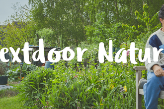 A father and daughter sit on a bench in a community garden, with a tree and bushes around them. The words 'Nextdoor Nature' appear overlaid