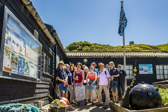 Volunteers standing outside Wild Seas Centre at Kimmeridge