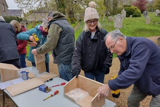 The Living Churchyard team at St Mary’s church in Piddlehinton making swift boxes