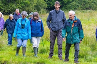 People walking through field