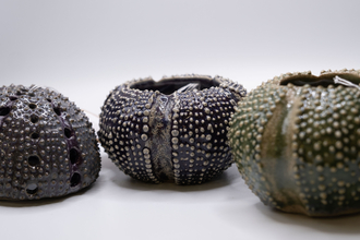 Three ceramic sea urchins