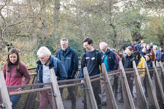 People attending sustainable business event walking up boardwalk on Brownsea Island