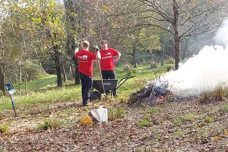 Two volunteers around a bonfire at Lorton Meadows