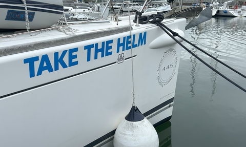 Front of Take the Helm boat showing the name
