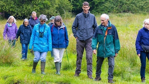 People walking through field