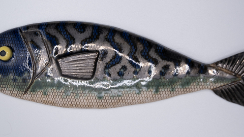 A ceramic sculpture of a mackerel