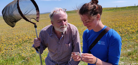 George and RSPB Uists Warden Heather Beaton with the great yellow bumblebee© Guthrie O’Brien 
