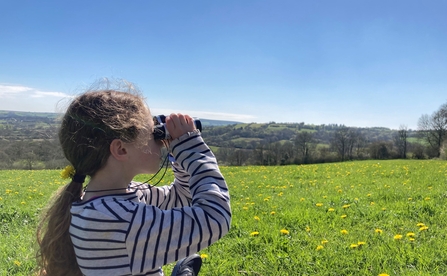Child with binoculars at Kingcombe 