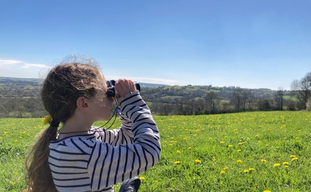 Child with binoculars at Kingcombe