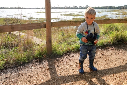 Grandson using binoculars at Upton Country Park