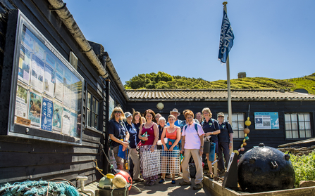 Volunteers standing outside Wild Seas Centre at Kimmeridge