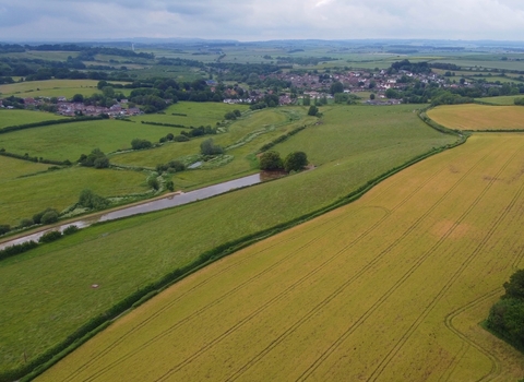 Aerial photo of the Court Farm site featuring fields and hedgerows